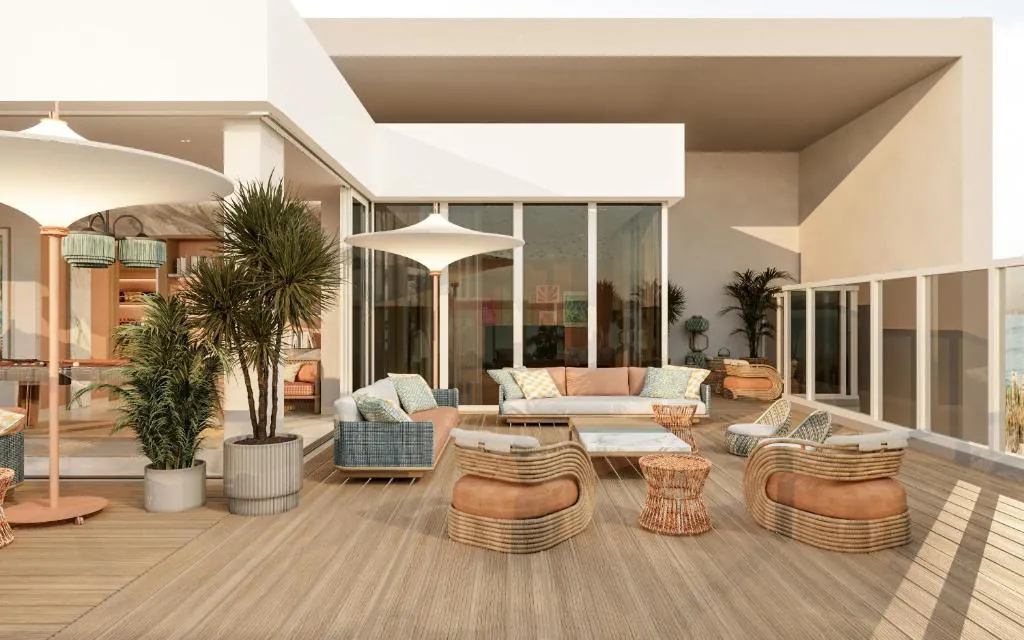 Z House La Terrasse: a rooftop deck of woven loungers, terracotta cushions and sculptural white parasols.